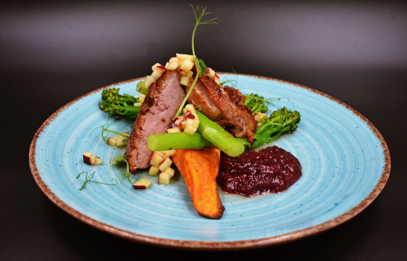 Duck breast in apple glaze with sweet potato quarters and cranberry salsa